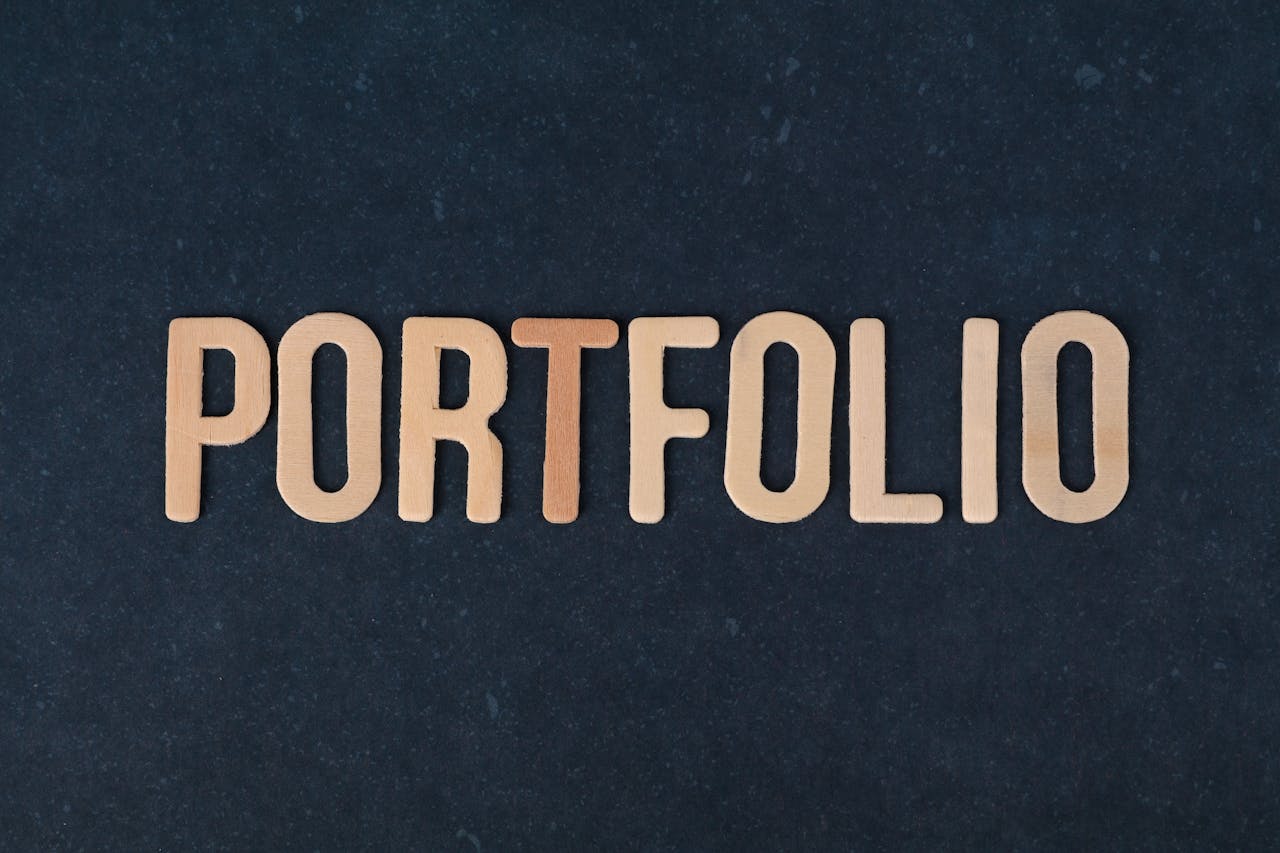 Wooden letters spelling the word 'portfolio' on a textured black background, ideal for creative projects.